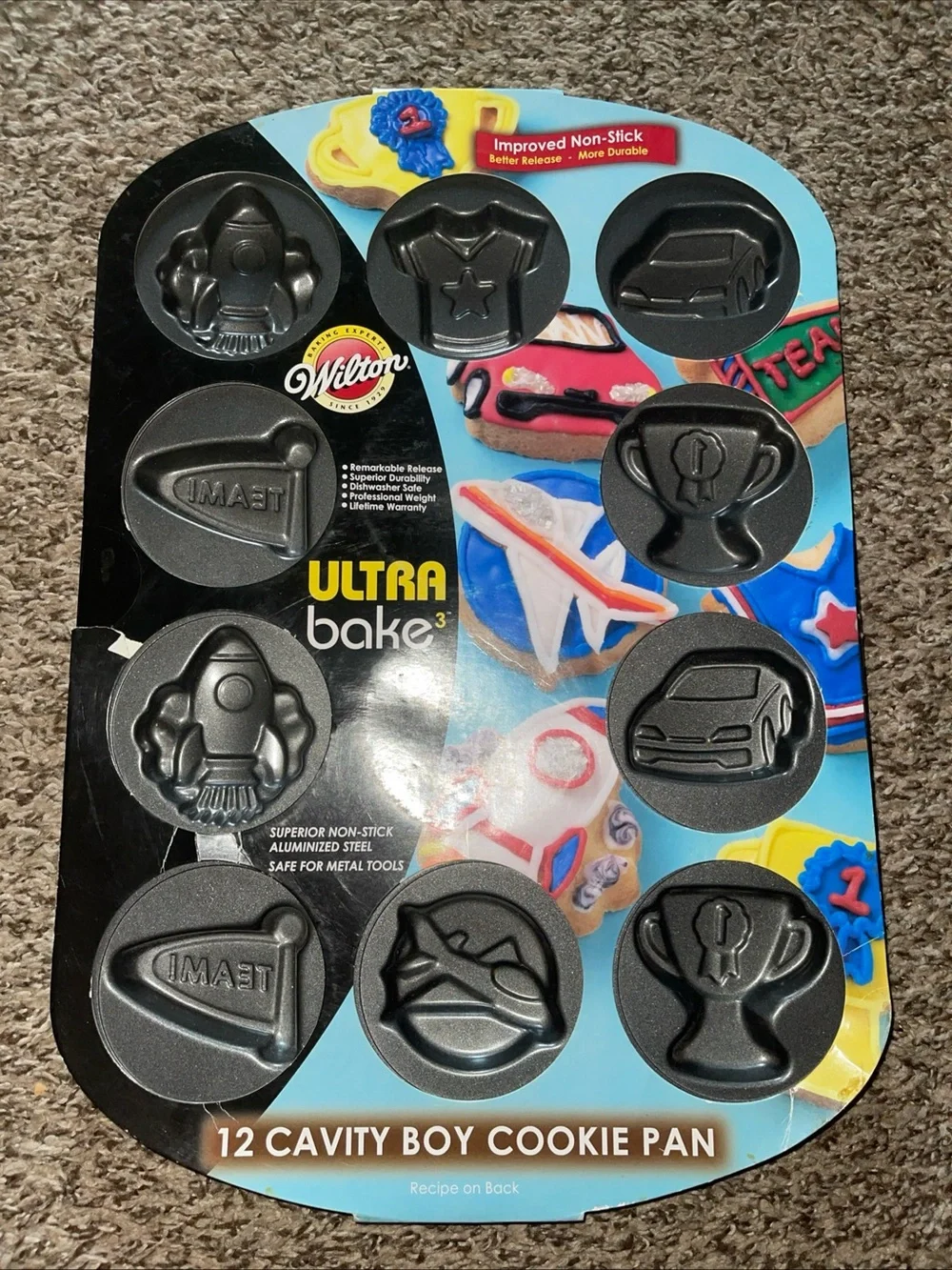 Wilton Ultra Bake 12-Cavity Boy Cookie Pan - Black and Blue Packaging